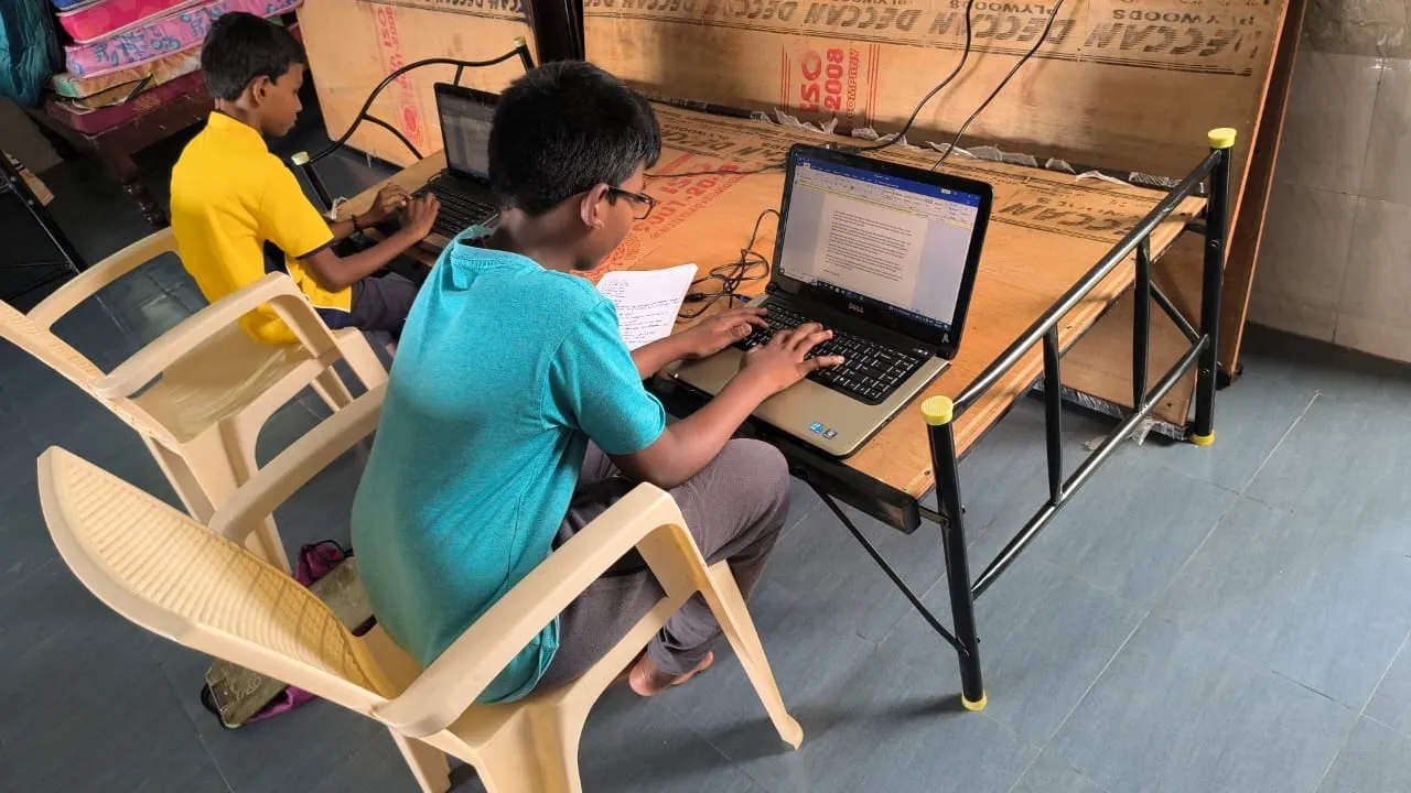 A child at a computer during the weekly computer awareness class