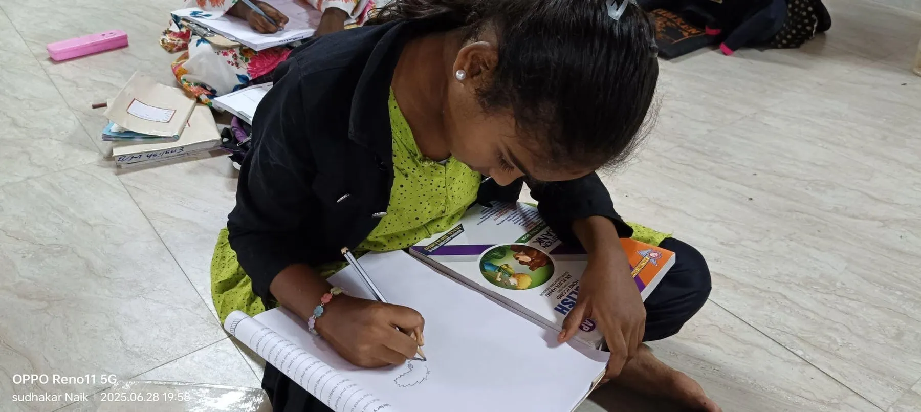 A student writing at the Kuteer