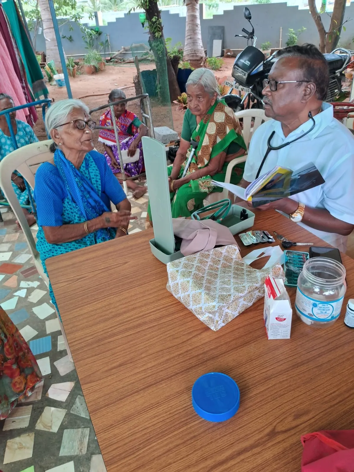 A doctor examining a patient's eyes at the free monthly eye camp
