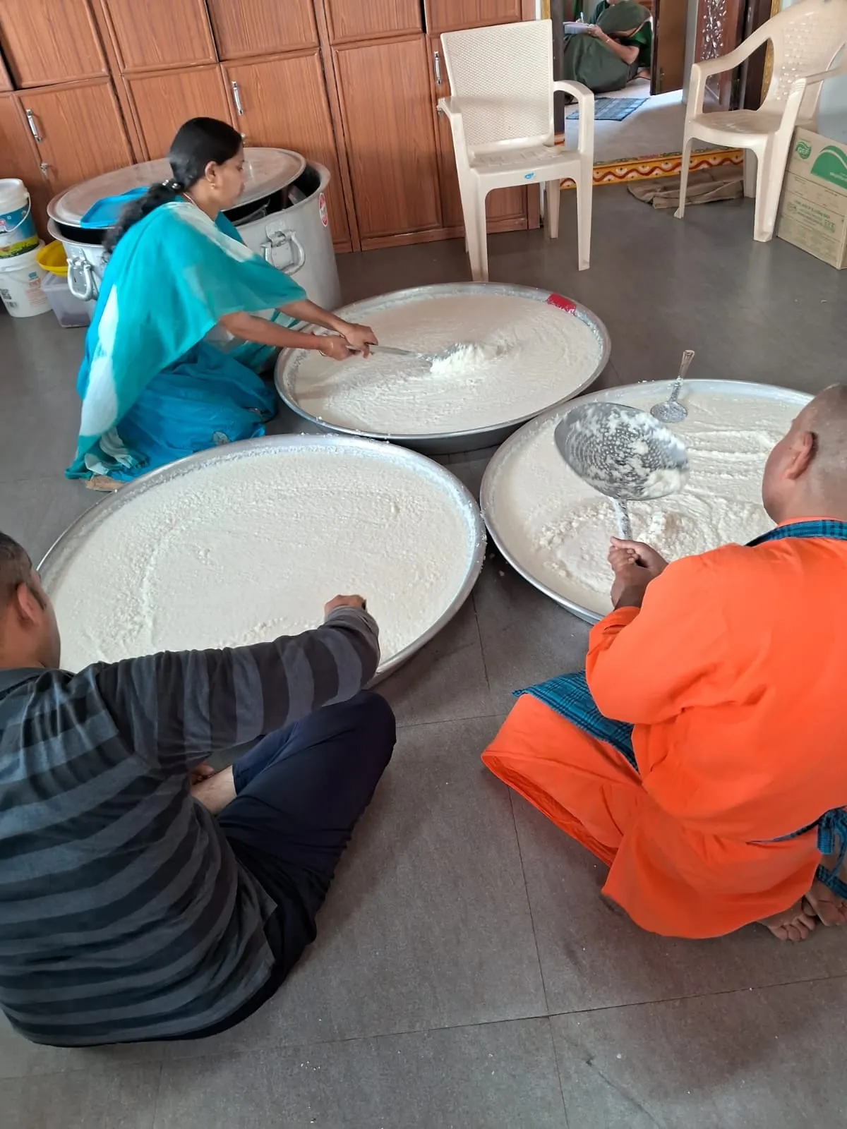 Plates and vessels laid out ahead of the monthly Narayana Seva