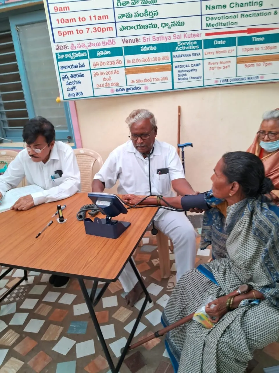A nurse taking an elderly patient's blood pressure