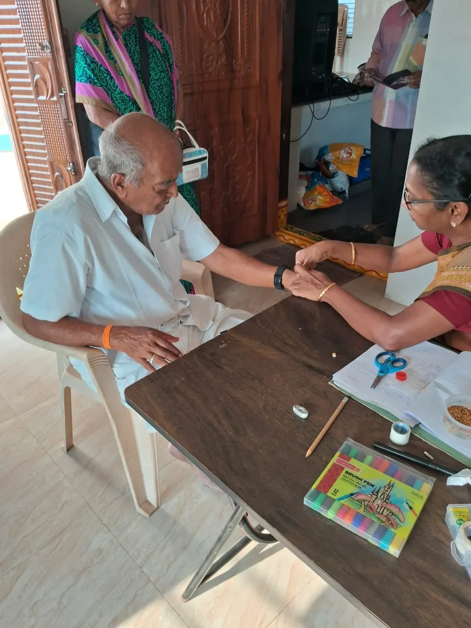 A physician listening to an elderly patient