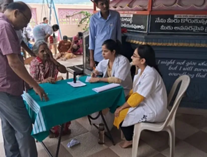 Medical staff seeing patients at the free monthly camp on the Kuteer premises