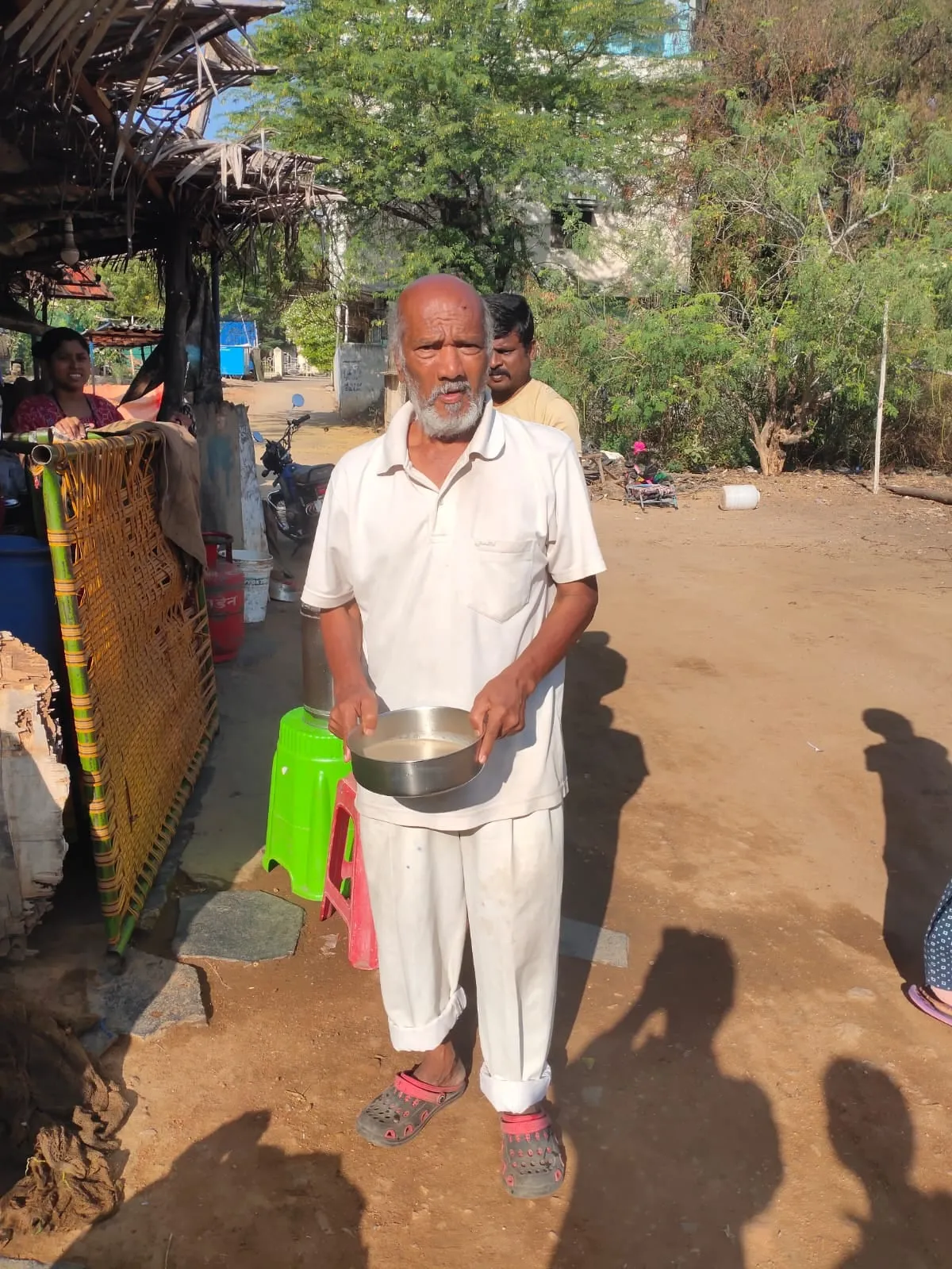 An elderly man on his way home with the morning meal