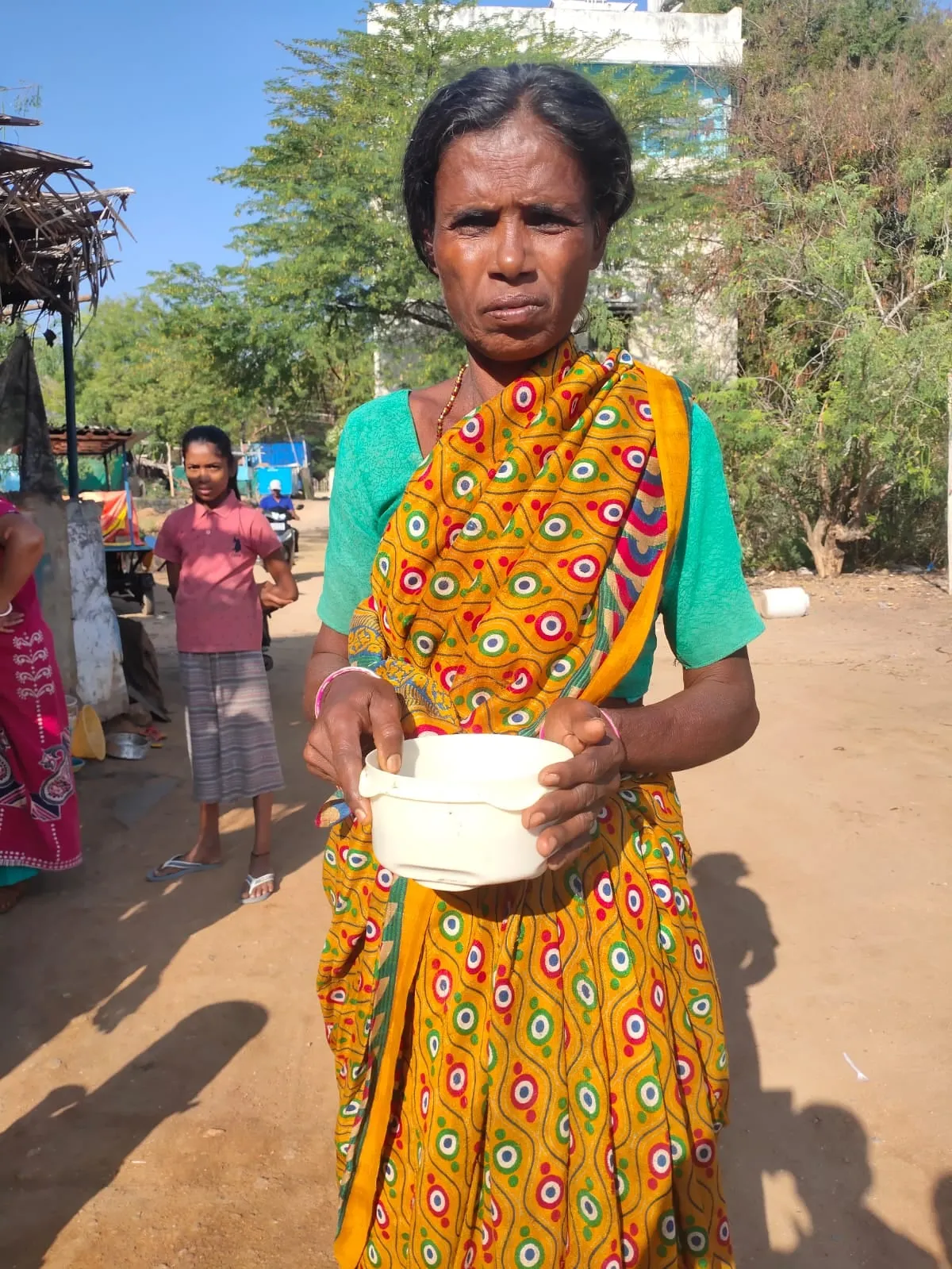 A woman receiving the morning breakfast on her doorstep