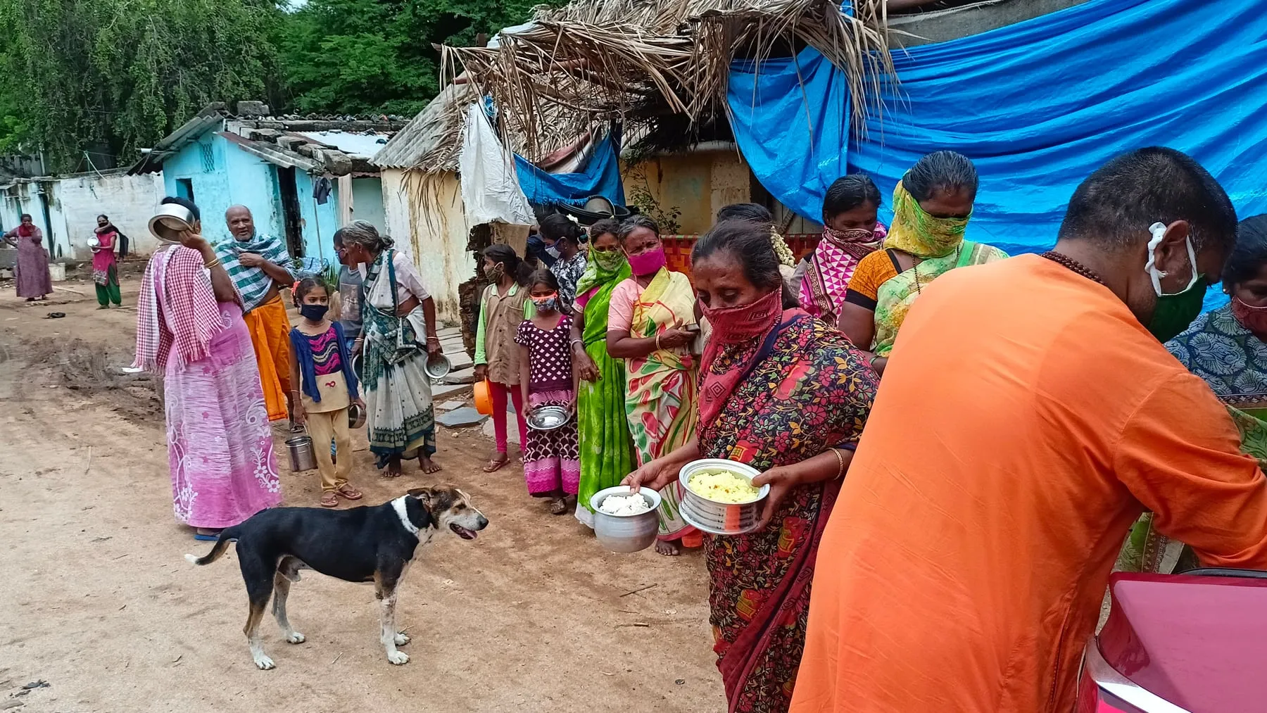 Villagers gathering with their vessels as the Narayana Seva arrives
