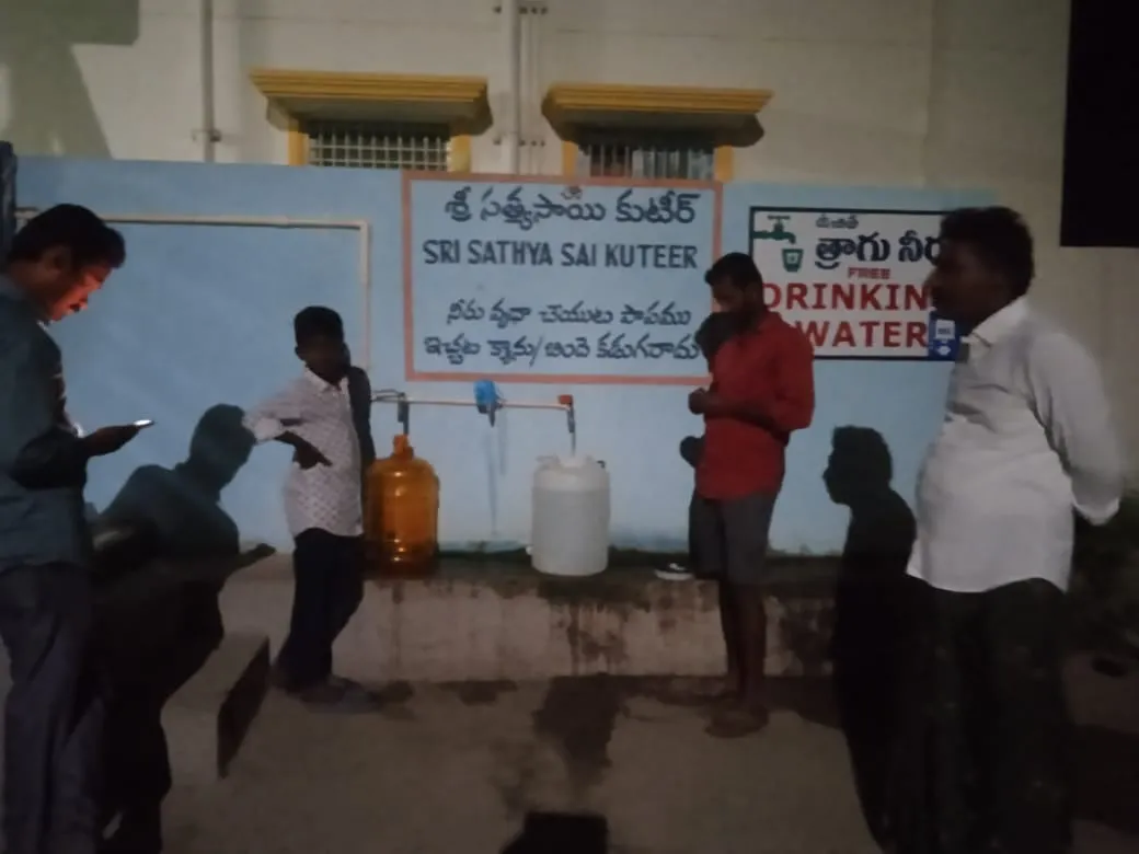 Collecting free drinking water beneath the Kuteer’s signboard